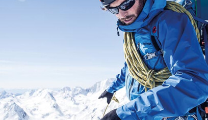 Mountaineer in a blue jacket roped up on a snowy peak, from Bergzeit, an Antavo loyalty customer