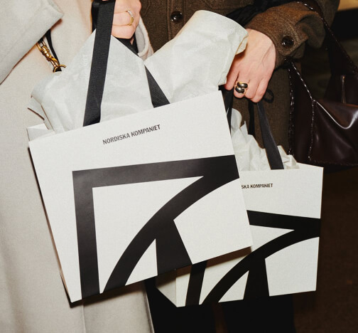 Shopper holding Nordiska Kompaniet bags, an Antavo loyalty program customer