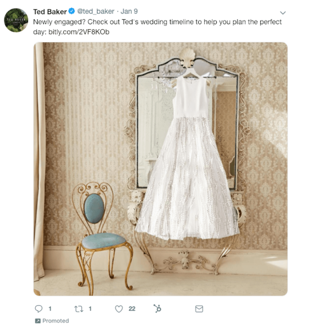 Image of Ted Baker’s Twitter post featuring an image of a wedding dress hanging over a mirror to advertise their products.